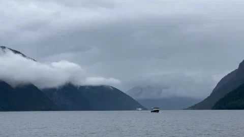The image features a cloudy seascape with a small boat Video stock 314072667