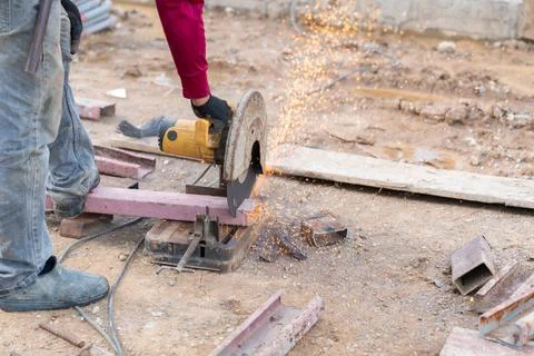 This image features a construction worker using a chop saw or cut-off saw t.. Stock Photos