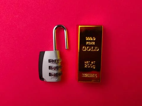 The image features a gold bar alongside a combination padlock Stock Photos