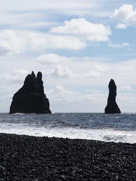 This image features iconic sea stacks set against the bright ocean and sky,.. Stock Photos