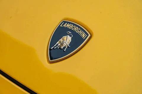 Image features Lamborghinis logo on a yellow background, symbolizing speed an Stock Photos