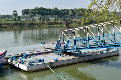 This image features a metallic blue floating pontoon bridge or ferry dock Stock Photos