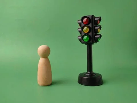 The image features a mini traffic light toy and a wooden peg doll Stock Photos