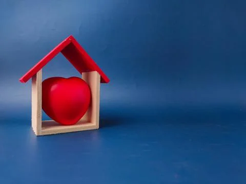 This image features a red heart inside a small wooden hous,the concept of l.. Stock Photos