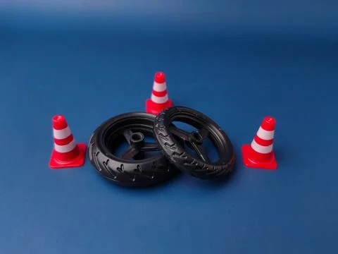 The image features a set of small plastic tires and miniature traffic cones.. Stock Photos