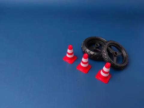 The image features a set of small plastic tires and miniature traffic cones.. Stock Photos