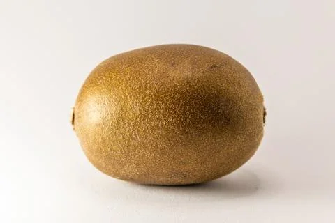 This image features a single kiwi fruit, captured to highlight its unique fuz Stock Photos