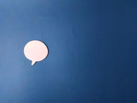The image features a single, light pink speech or chat bubble set against a.. Stock Photos