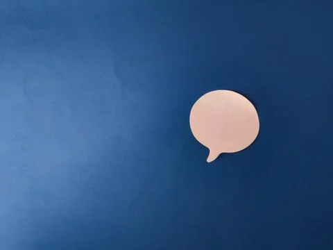 The image features a single, light pink speech or chat bubble set against a.. Stock Photos