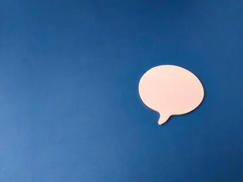 The image features a single, light pink speech or chat bubble set against a.. Stock Photos