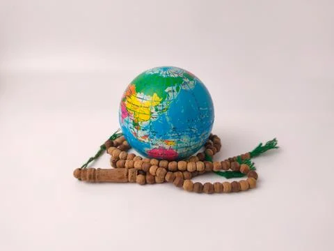 The image features a small worldglobealongside a set ofMuslim prayer beads Stock Photos
