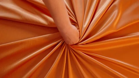  image features a swirling pattern of satin fabric in a rich orange color. The f Stock Footage 262630216