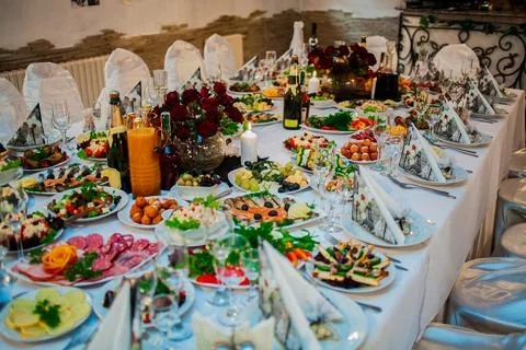 The image features a table beautifully set for a meal. Stock Photos