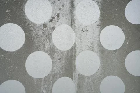 The image features a textured gray background with a pattern of large, irre.. Stockfoto's