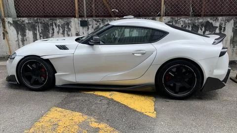 The image features a white Toyota GR Supra A90 generation Stock Photos