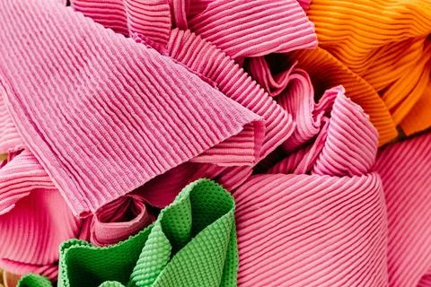 Image featuring an array of various-sized and colored fabrics Stock Photos