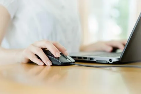 Image of female hands clicking computer mouse Stock Photos
