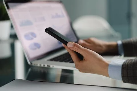 Image of female hands using mobile phone app for synchronizing data with netb Stock Photos