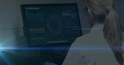 Image of female scientist looking at computer screen with data processing Foto stock