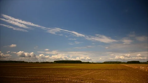Image of field and bright blue sky; timelapse Stock Footage 89673268