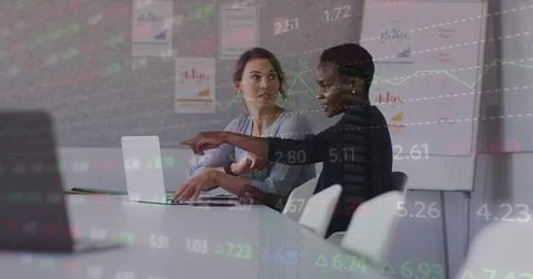 Image of financial data and graphs over diverse female coworkers in office Stock Photos