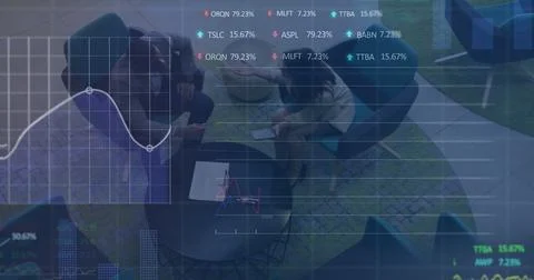 Image of financial data and graphs over diverse coworkers in office Stock Photos