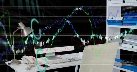 Image of financial data processing with fluctuating lines over office desk 库存照片