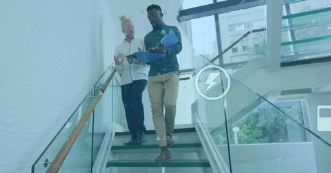 Image of financial data processing with icons over diverse business people Foto stock