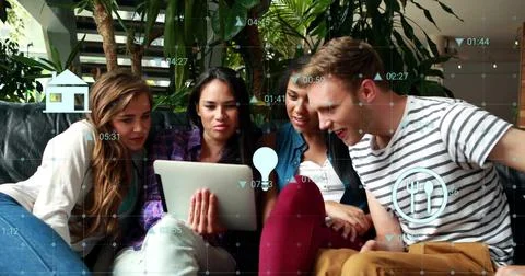 Image of financial data processing with icons over diverse colleagues using.. Foto stock