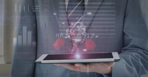 Image of financial data processing over businessman using tablet 写真素材