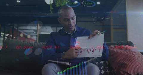 Image of financial data processing over biracial businessman working 写真素材