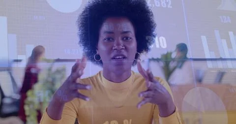 Image of financial data processing over african american businesswoman working Stockfoto's