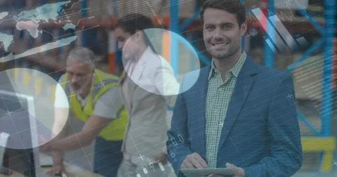 Image of financial data processing over smiling man working in warehouse Foto stock
