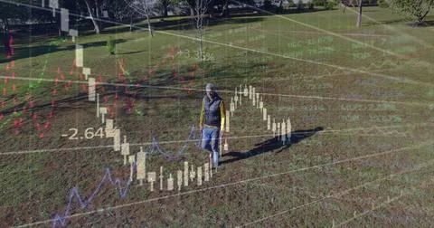 Image of financial data processing over caucasian man walking in park 스톡 사진