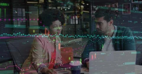 Image of financial data processing over diverse man and woman discussing ov.. Foto stock