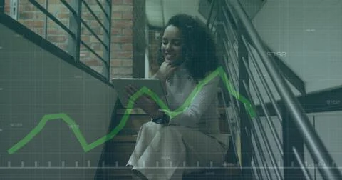 Image of financial data processing over biracial businesswoman in office 스톡 사진