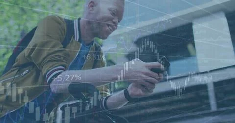 Image of financial data processing over man using smartphone 스톡 사진