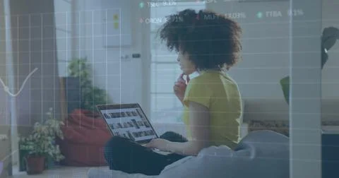 Image of financial data processing over biracial businesswoman using computer Stockfoto's