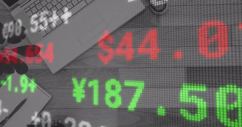Image of financial data processing over desk with laptop 库存照片
