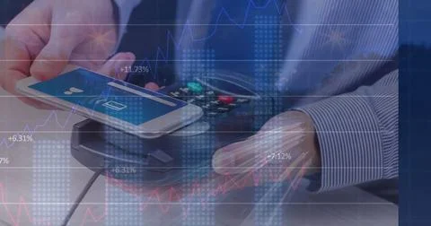 Image of financial data processing over man with smartphone and payment terminal Stock Photos