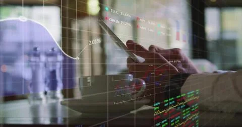 Image of financial data processing over businessman using tablet Stock Photos