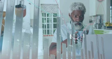 Image of financial data processing over senior african american man using laptop Stock Photos