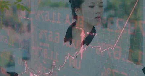 Image of financial data processing over asian businesswoman using computer Stock Photos