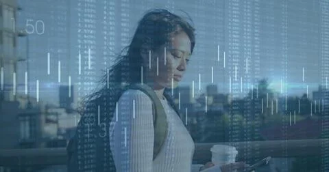 Image of financial data processing over biracial woman using smartphone in city Foto stock