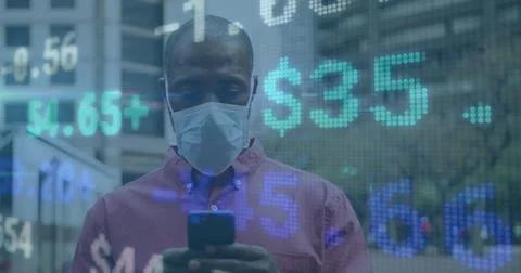 Image of financial data processing over african american man in face mask using Foto stock