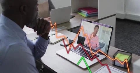 Image of financial data processing over diverse business people on laptop image Foto stock