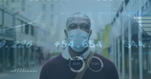 Image of financial data processing over african american man in face mask Stock Photos