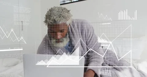 Image of financial data processing over senior african american man using laptop Stock Photos
