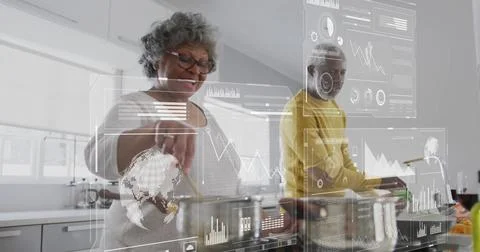 Image of financial data processing over biracial senior couple in kitchen Stock Photos