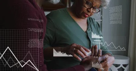 Image of financial data processing over biracial senior couple at home Foto stock